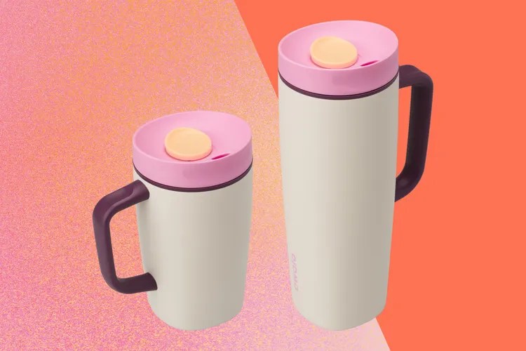 Two insulated travel mugs side by side, one with a handle and one without, featuring a pink and cream color scheme against an orange background.